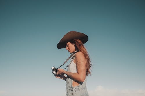 Woman Wearing Hat and Holding Camera