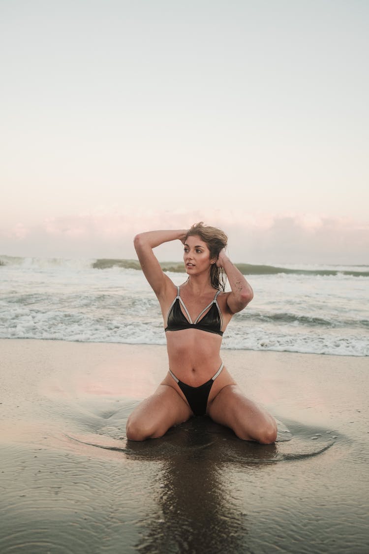 Woman Wearing Bikini Posing On Beach