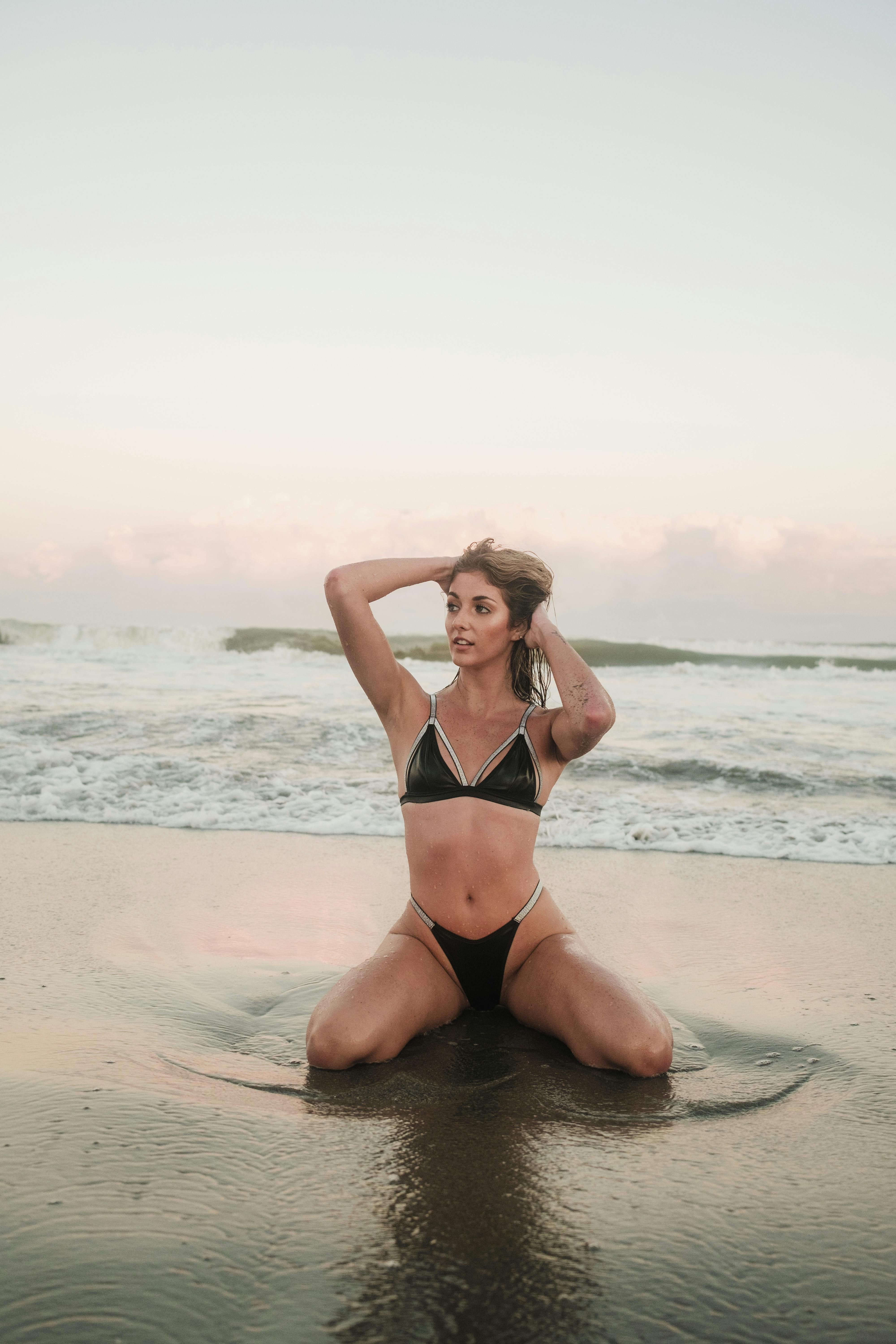free photo of woman wearing bikini posing on beach