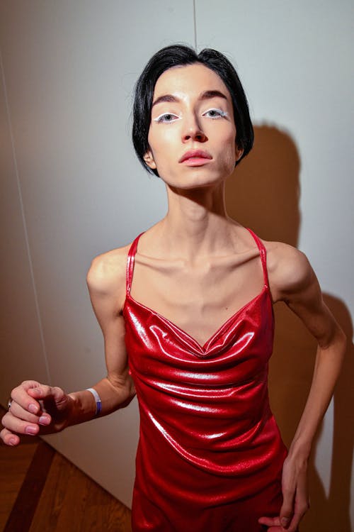 Young Woman Wearing a Shiny Red Dress 