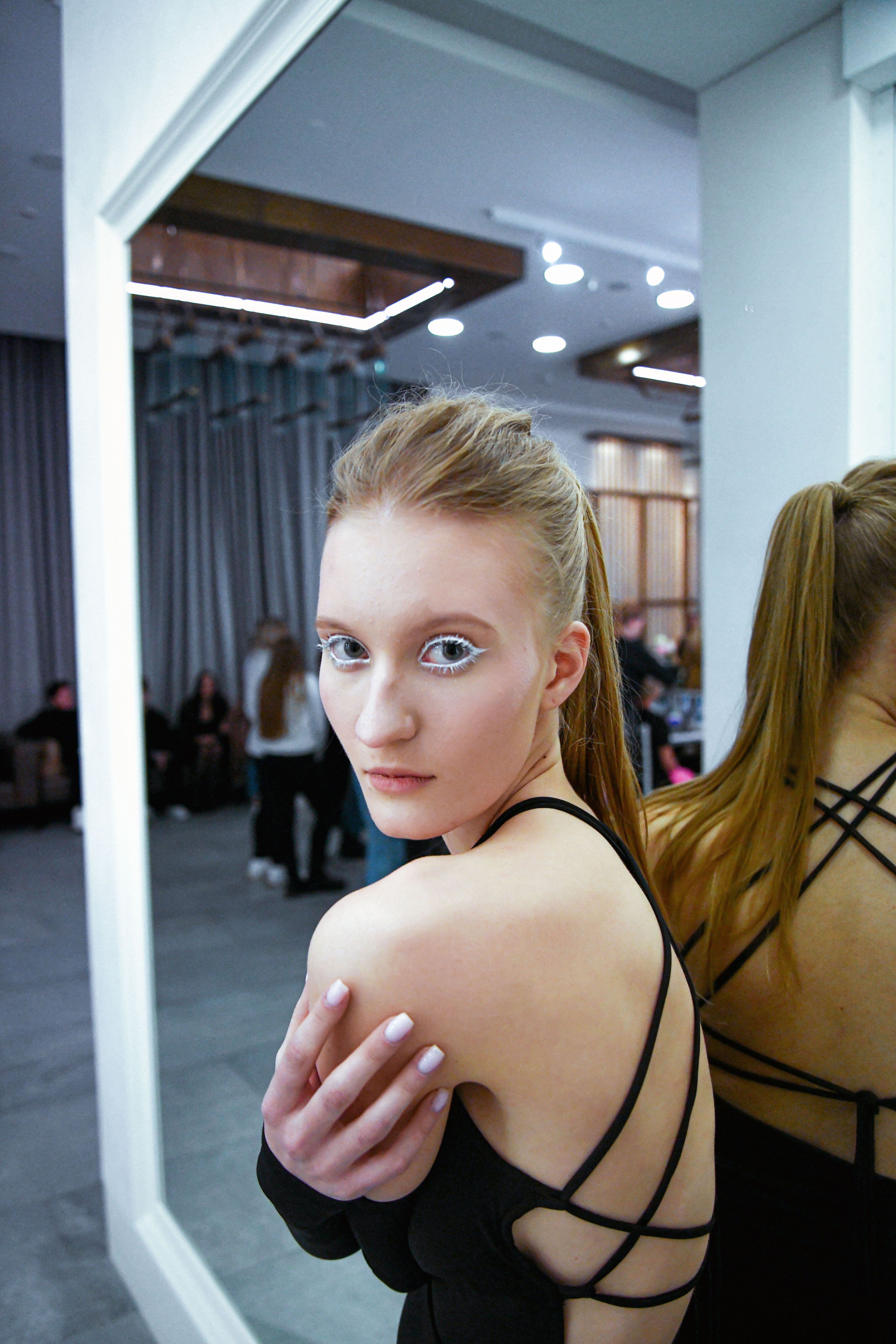 Fashion model preparing backstage in a studio