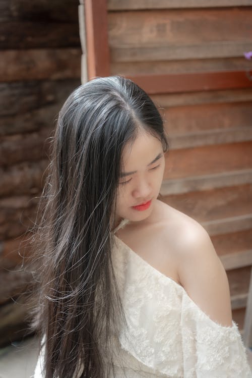 Young Woman in Off the Shoulder White Blouse