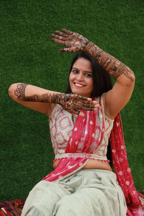 Free A joyful woman with intricate henna tattoos wearing traditional Indian clothing, smiling and posing. Stock Photo