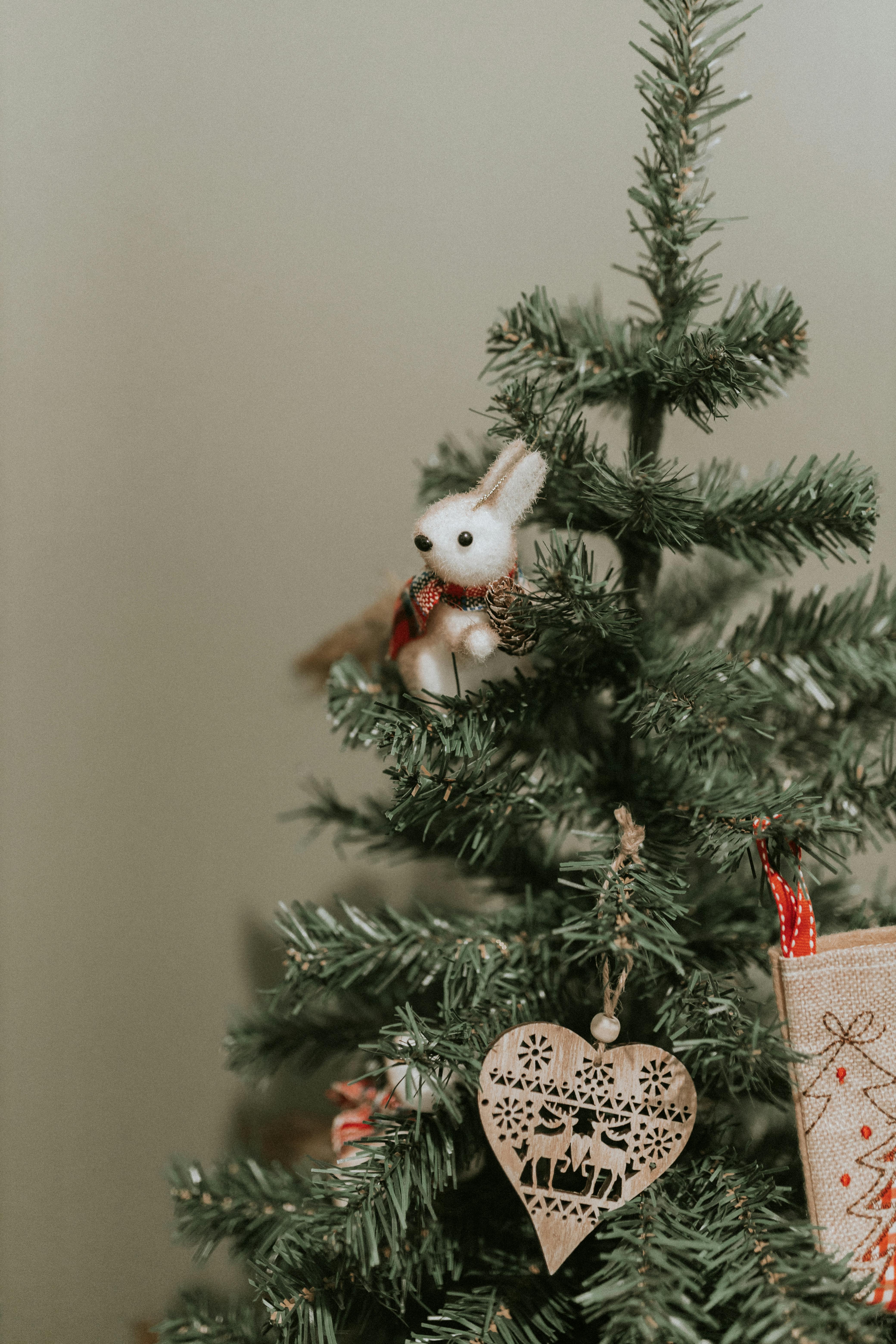 Close-up of a decorated Christmas tree featuring a cute bunny ornament and wooden decorations.