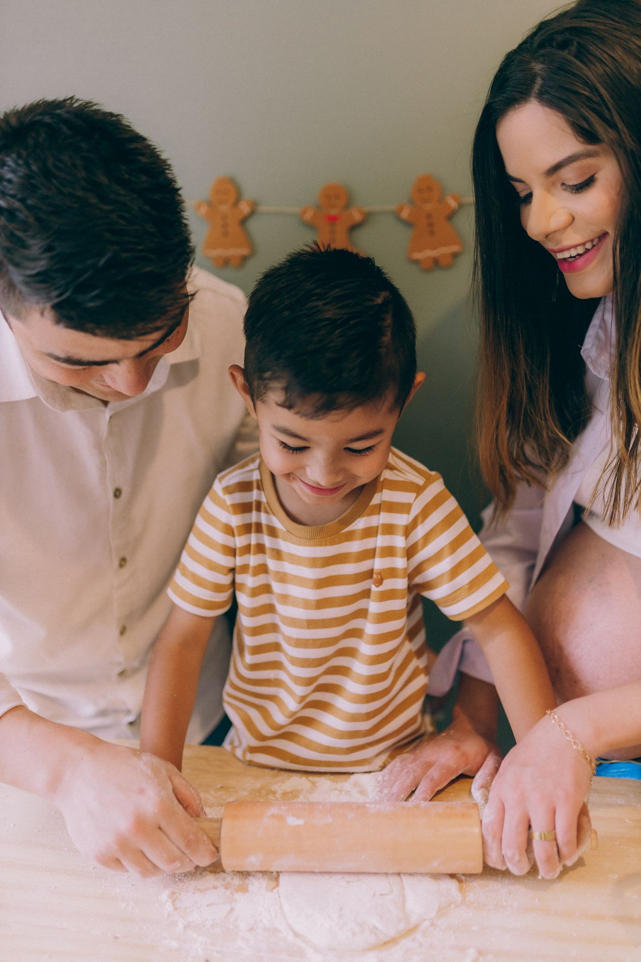 Family baking Christmas cookies together in a full-color kitchen scene