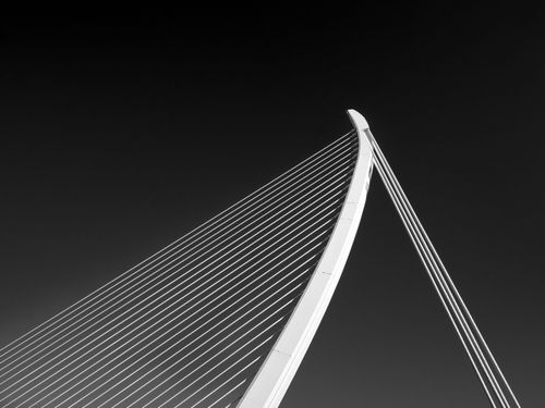 Free Black and white image capturing the modern architectural lines of a Valencia bridge under a clear sky. Stock Photo