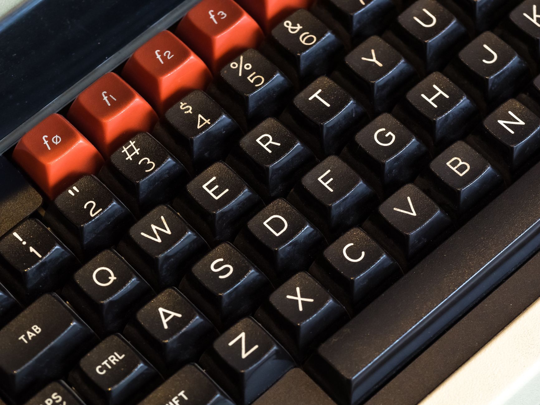 Detailed close-up of a vintage computer keyboard featuring colored keys and retro design.