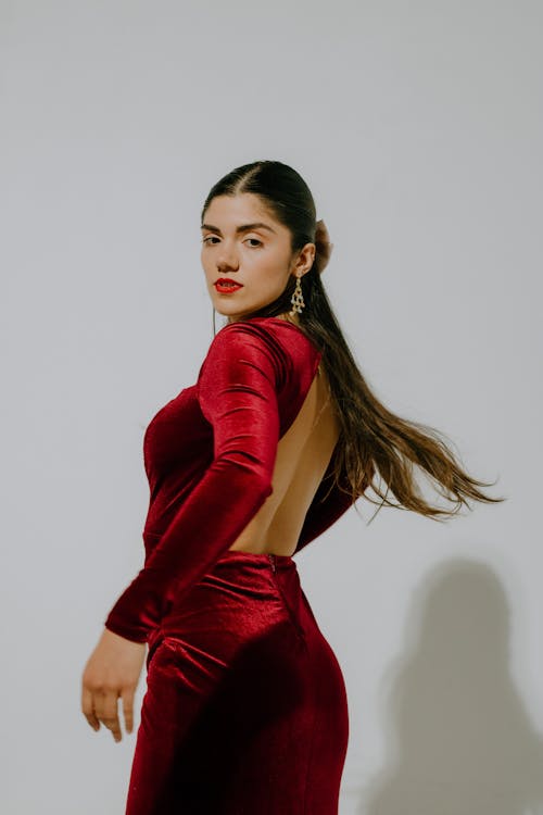 Young Woman in Red Dress Posing in Studio