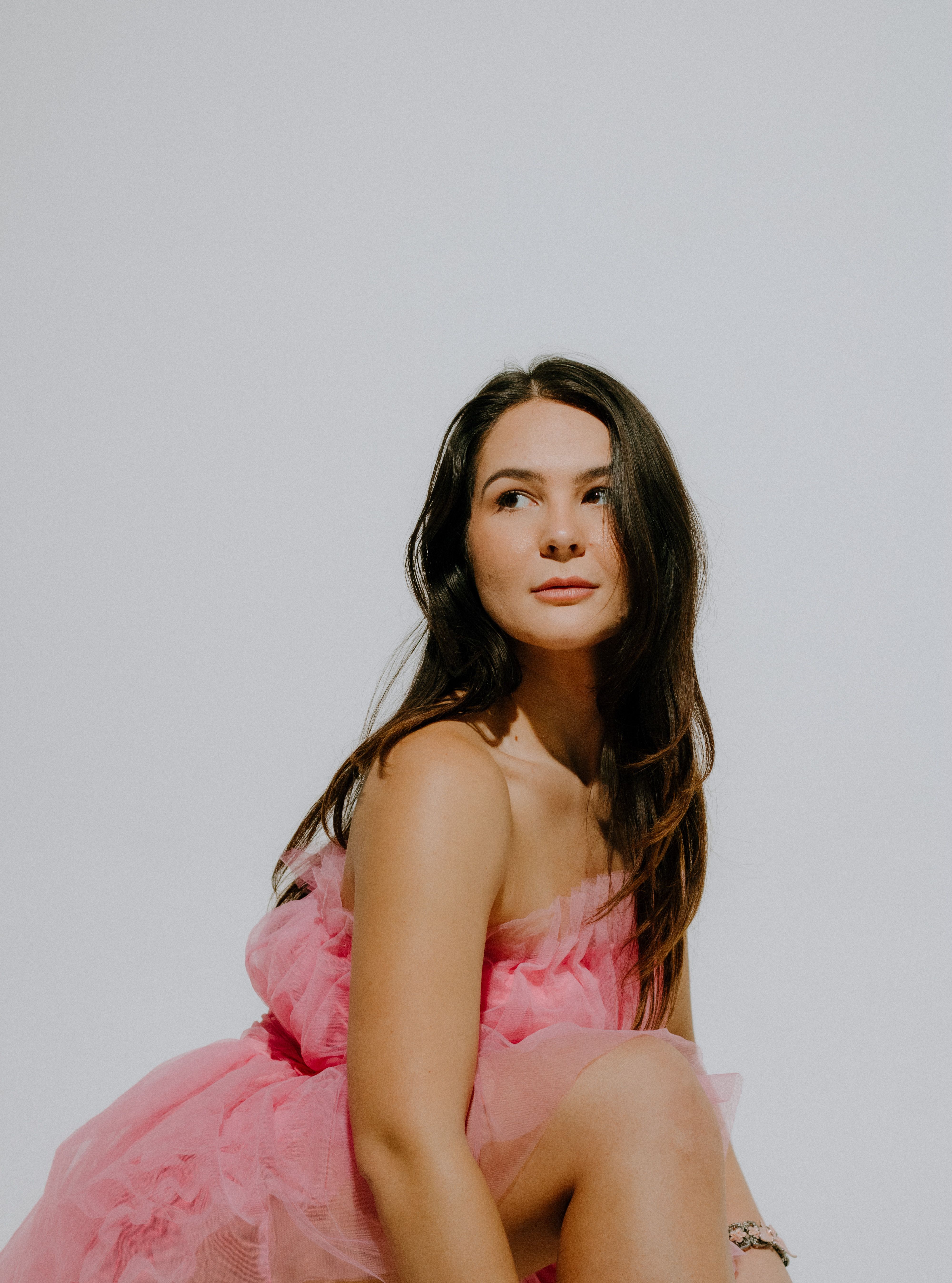 Brunette in Pink Dress Posing in Studio · Free Stock Photo