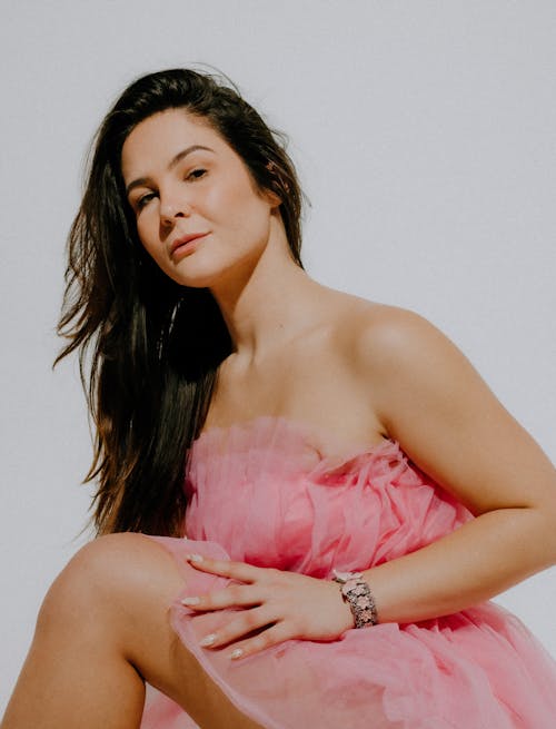 Young Woman in Pink Dress Posing in Studio