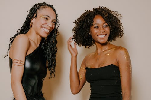 Smiling Women in Black Dresses Posing in Studio