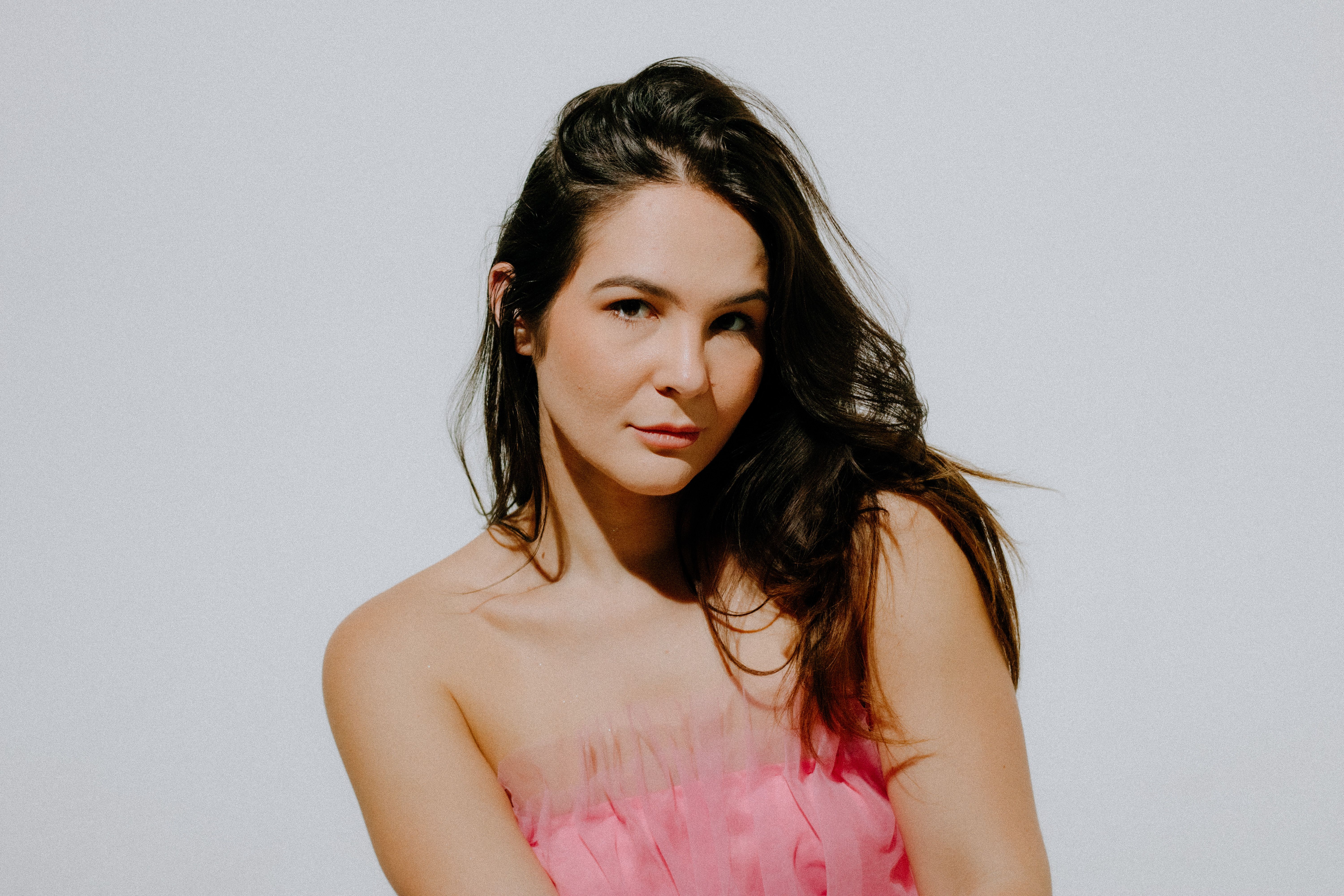 Brunette in Pink Top Posing in Studio · Free Stock Photo