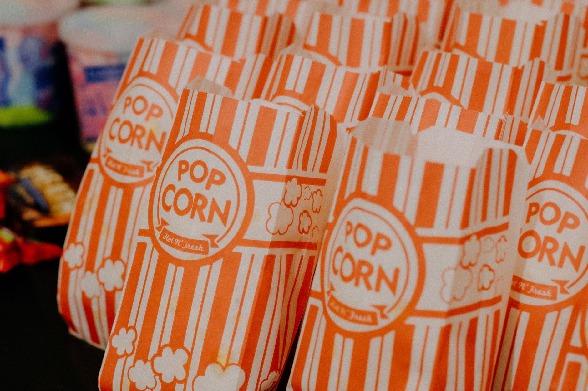 popcorn machine rental egypt — Colorful striped popcorn bags neatly arranged, ready for serving at a concession stand.