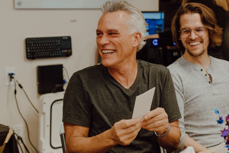 Smiling Men Talking In Computer Room