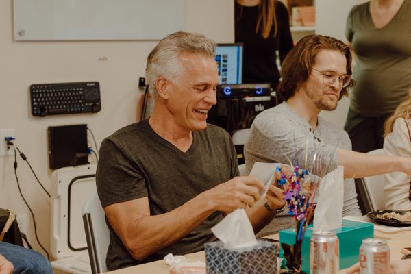 Two teammates enjoying a laugh over a craft project — Nino Sanger on Pexels