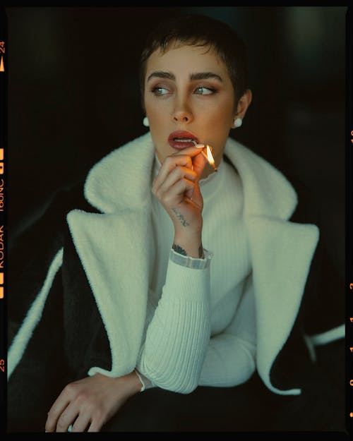 Model in Sweater Posing with Burning Match