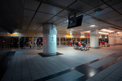 People Sitting on Benches at Railway Station Hall