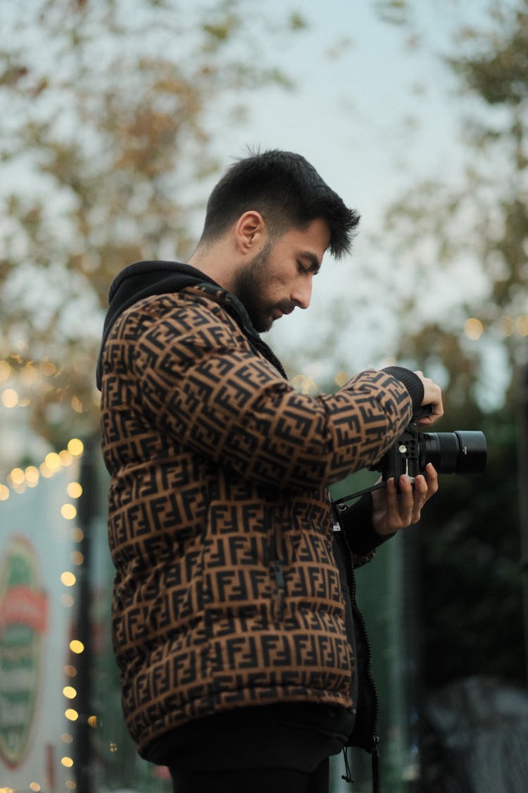 Man In Jacket Standing With Camera