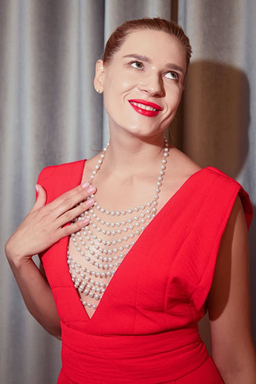Young Elegant Woman in a Red Dress and Red Lipstick