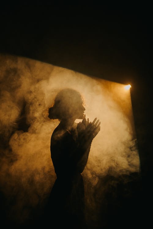Silhouette of Woman Among Smoke 