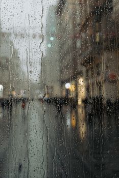 Rainy day view through a tram window capturing urban Istanbul streets in a moody ambiance.