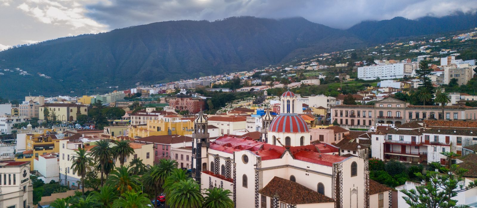 Scenic aerial photograph capturing La Orotava's historic architecture against mountainous backdrop.