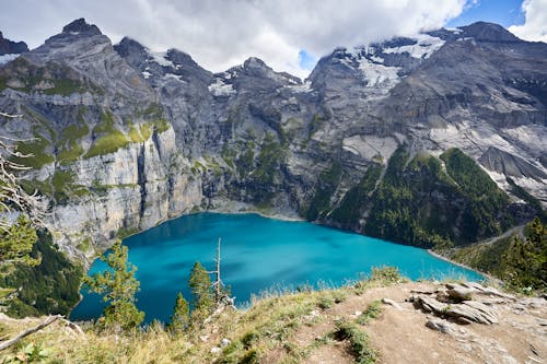 Free View of the Oeschinen Lake in Mountains in Switzerland  Stock Photo