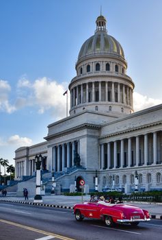 Capture of Havana's iconic El Capitolio and a classic vintage car on the street.