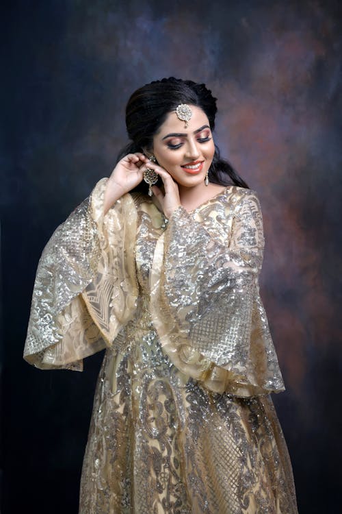 Model in Glistening Dress Wearing Traditional Jewelry