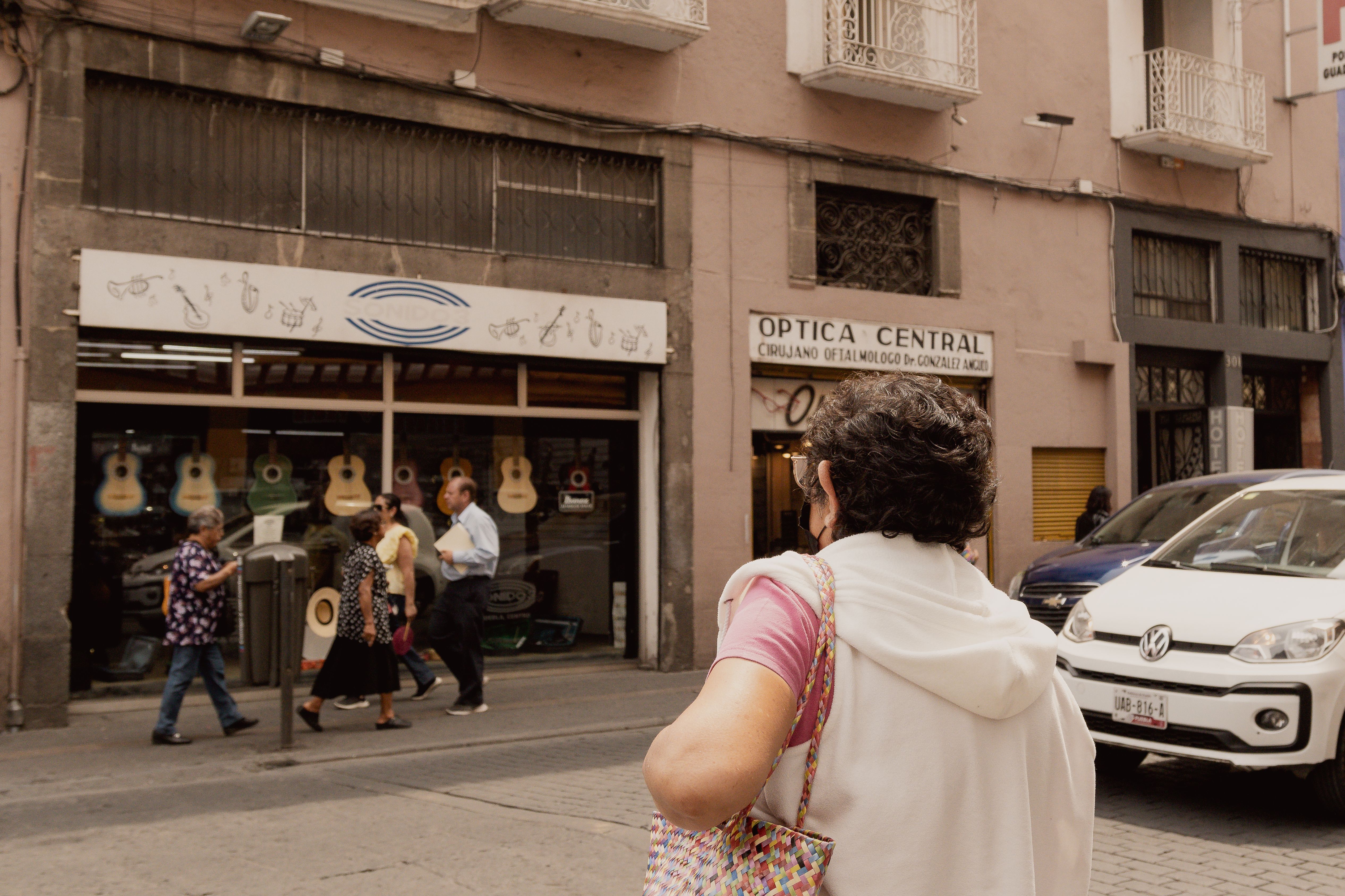 A bustling street in Puebla, Mexico featuring pedestrians and local shops.