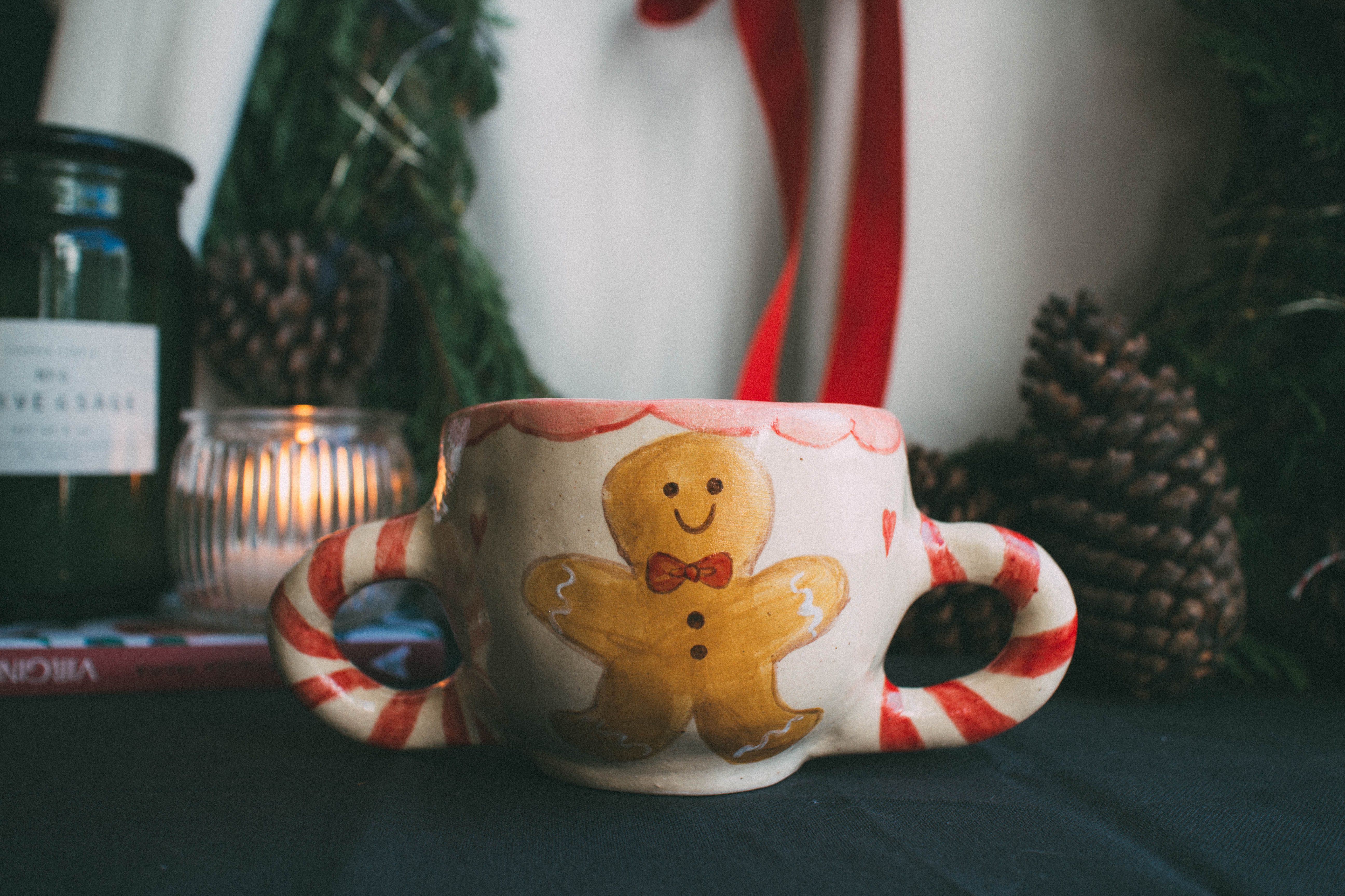 Gingerbread Man Mug Mate hanging on a mug with cocoa