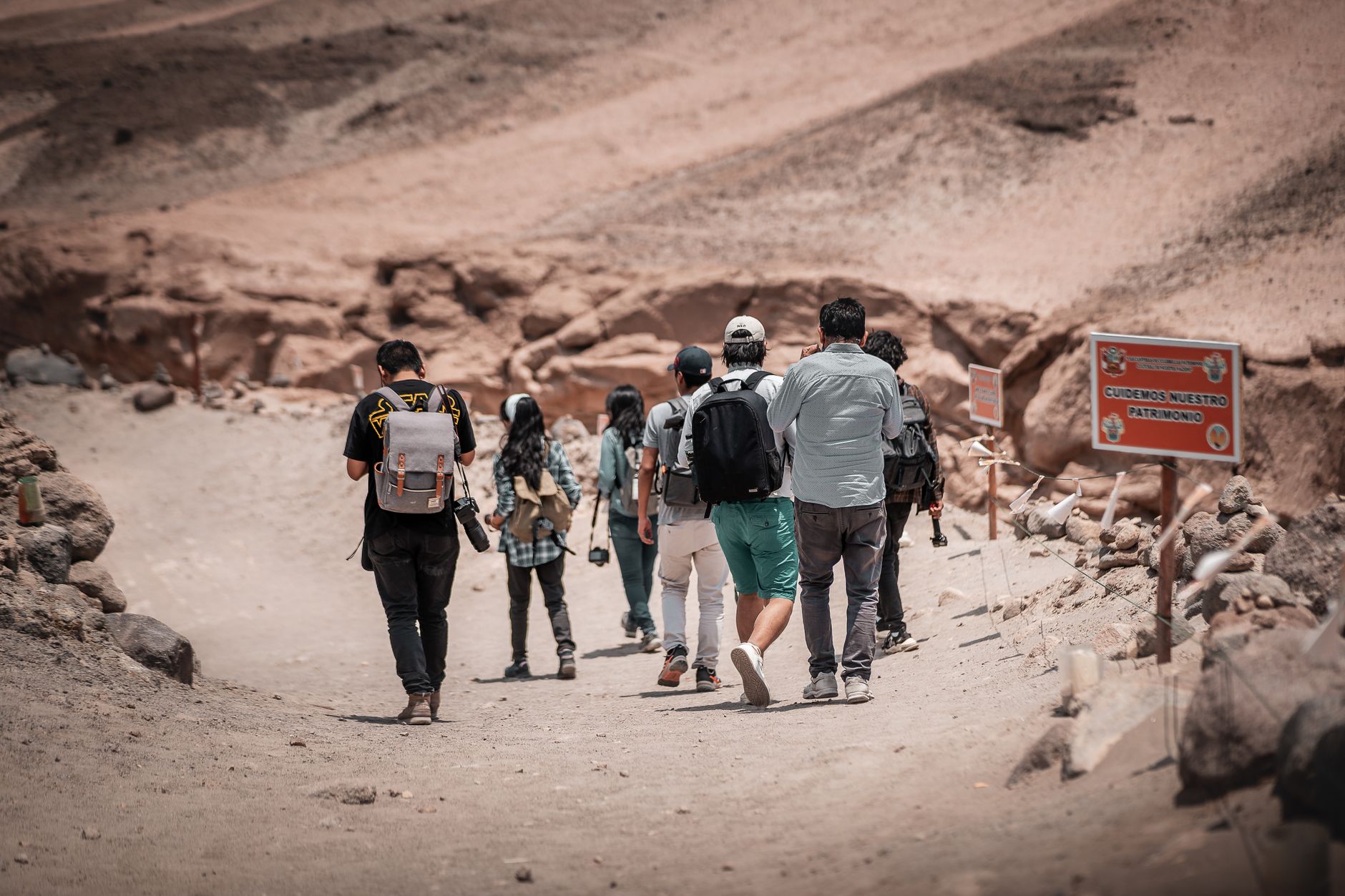 A group of hikers explores the arid terrain of Arequipa, Peru, creating a sense of adventure.