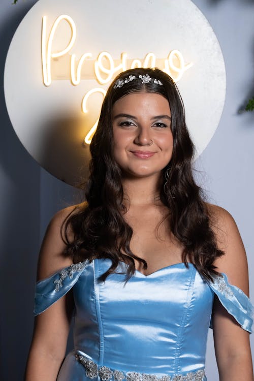 Young Elegant Woman in a Satin Dress Standing and Smiling 