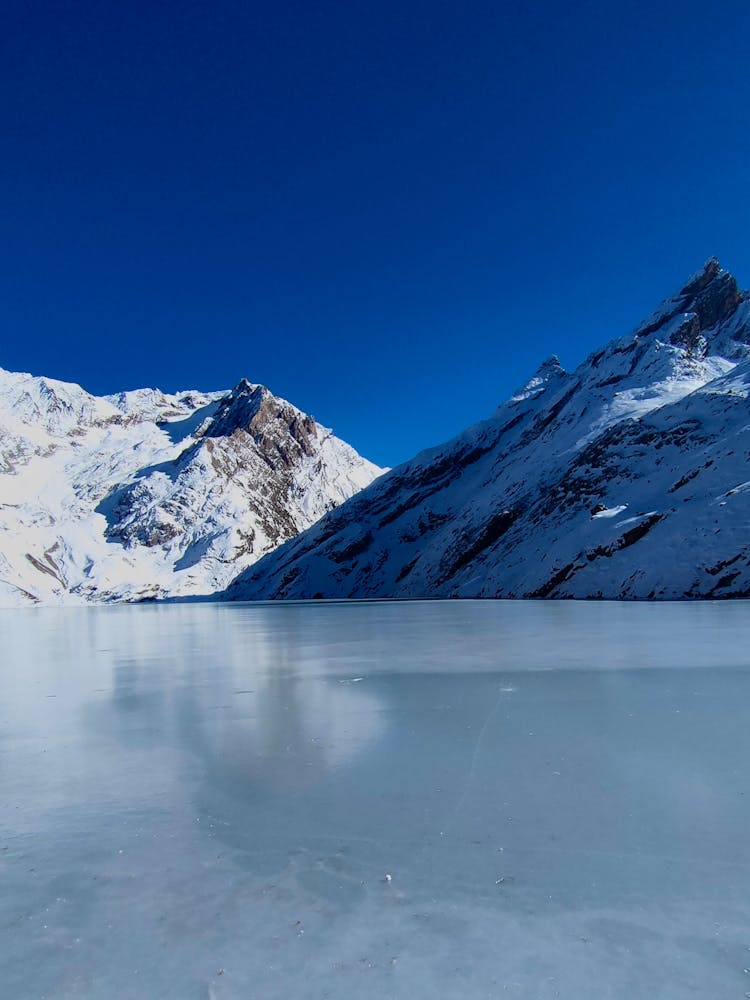 Frozen Lake In Snowy Mountains