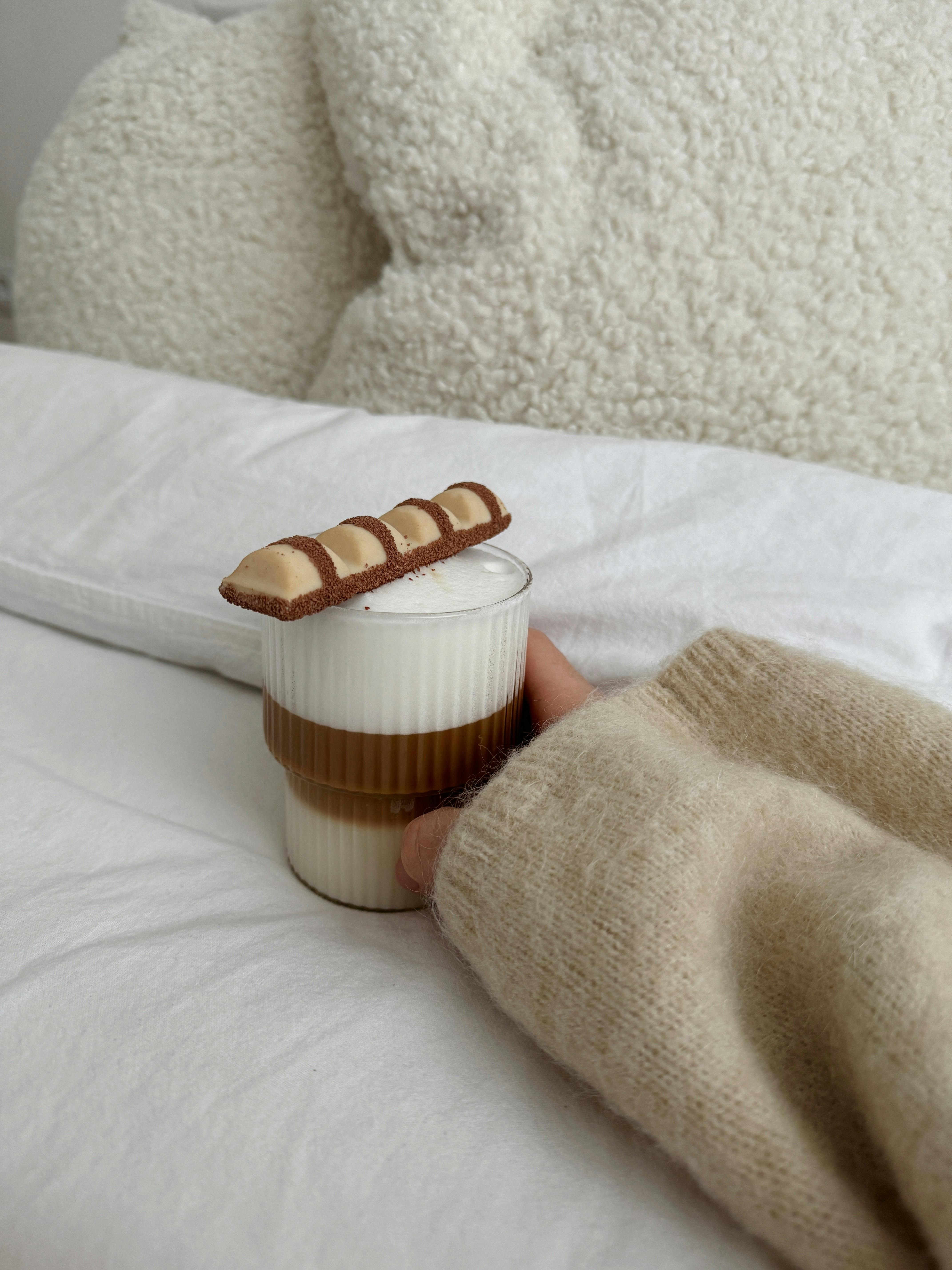 Warm cup of hot chocolate topped with a chocolate bar, creating a cozy vibe.