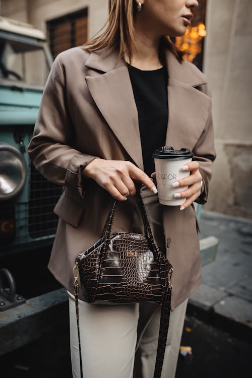 Stylish Woman with Takeaway Coffee on Street