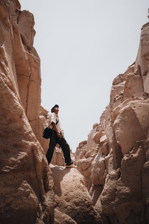 Man Climbing Rocks in Canyon