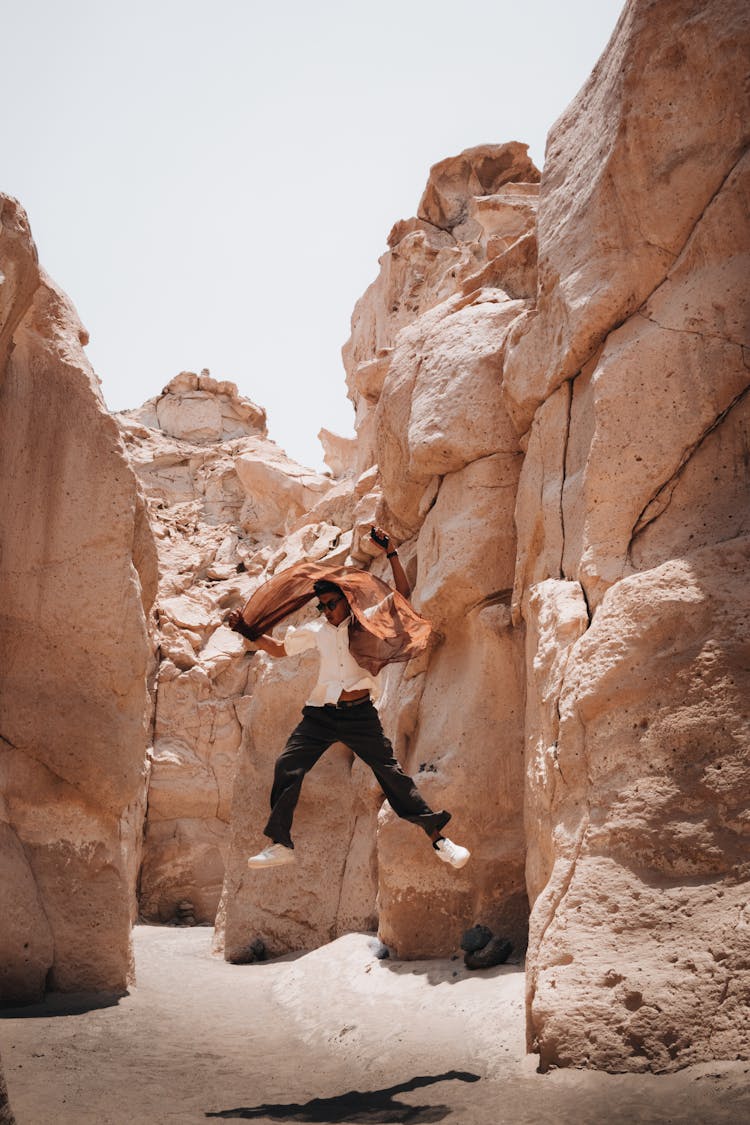 Man Jumping In Canyon