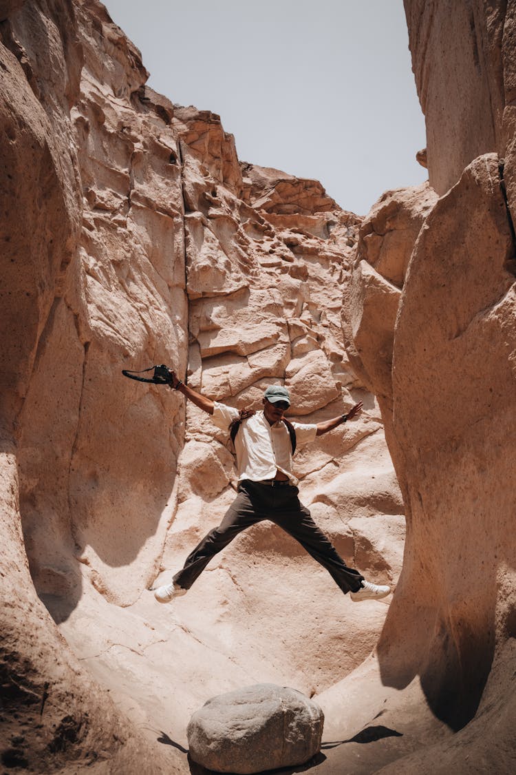 Man Jumping In Canyon 