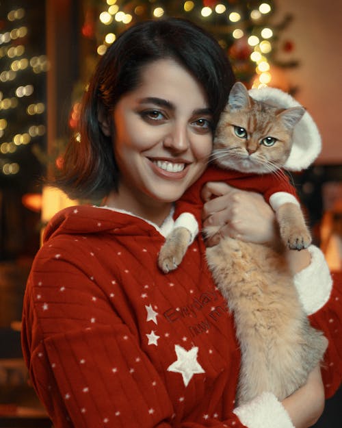 Smiling Woman and Cat in Christmas Pajamas