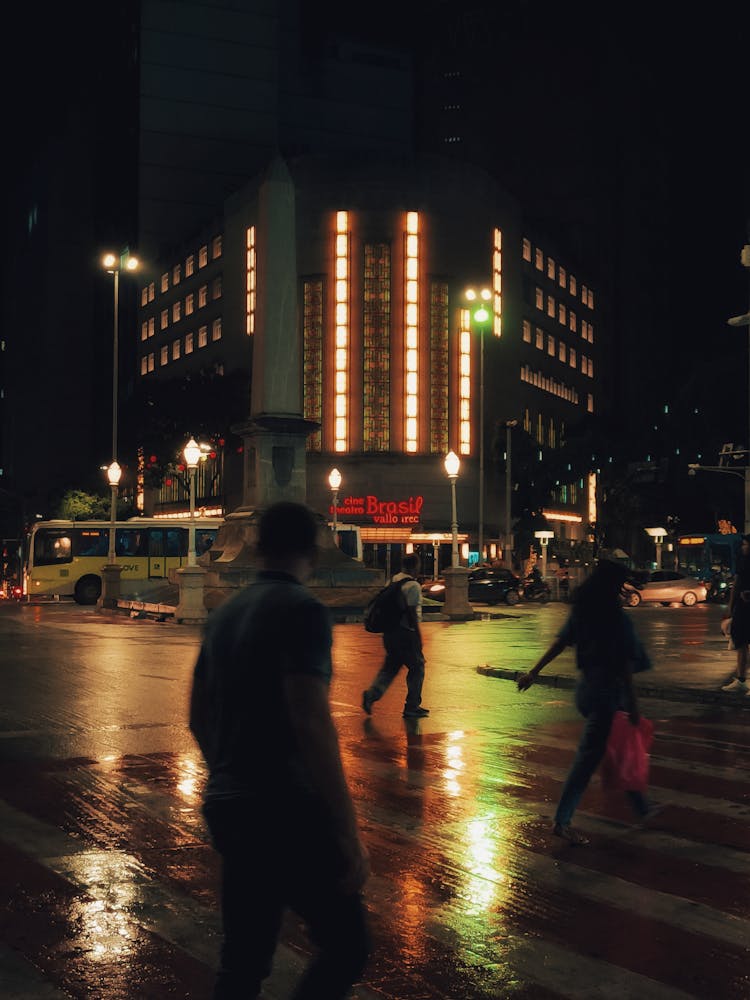 People Crossing Street At Night