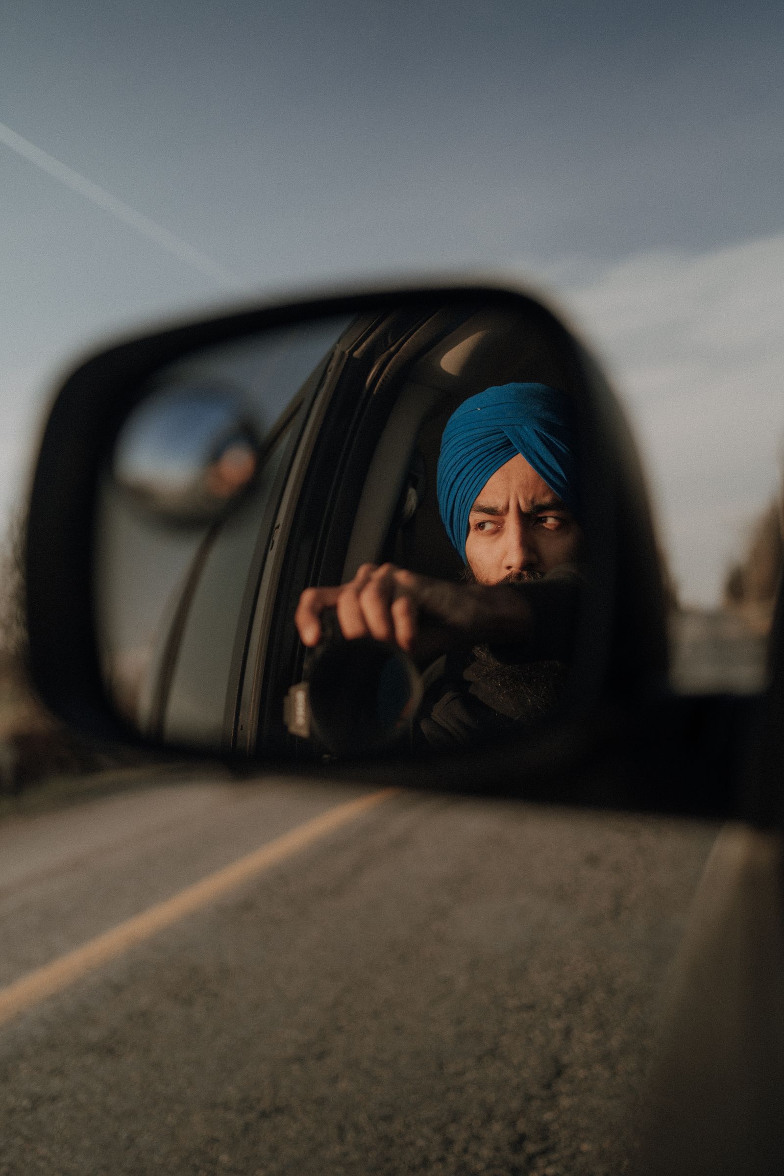 Person Taking a Self Portrait on a Rear View Mirror · Free Stock Photo