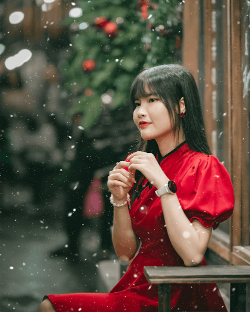 Snowfall over Woman in Red Clothes