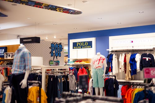 A clothing store with a skateboard on display