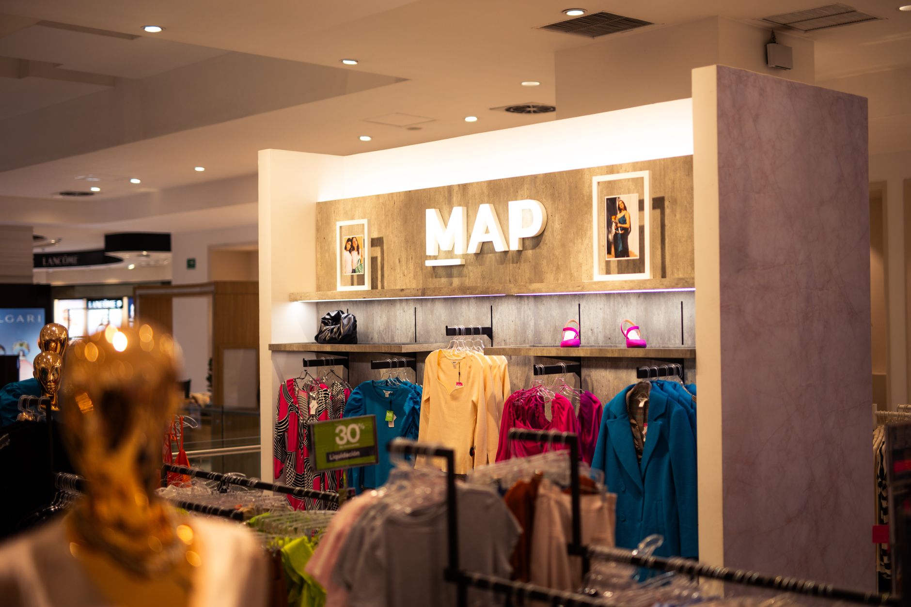 Explore a fashion retail store interior featuring designer clothing and vibrant colors, ideal for shopping enthusiasts.
