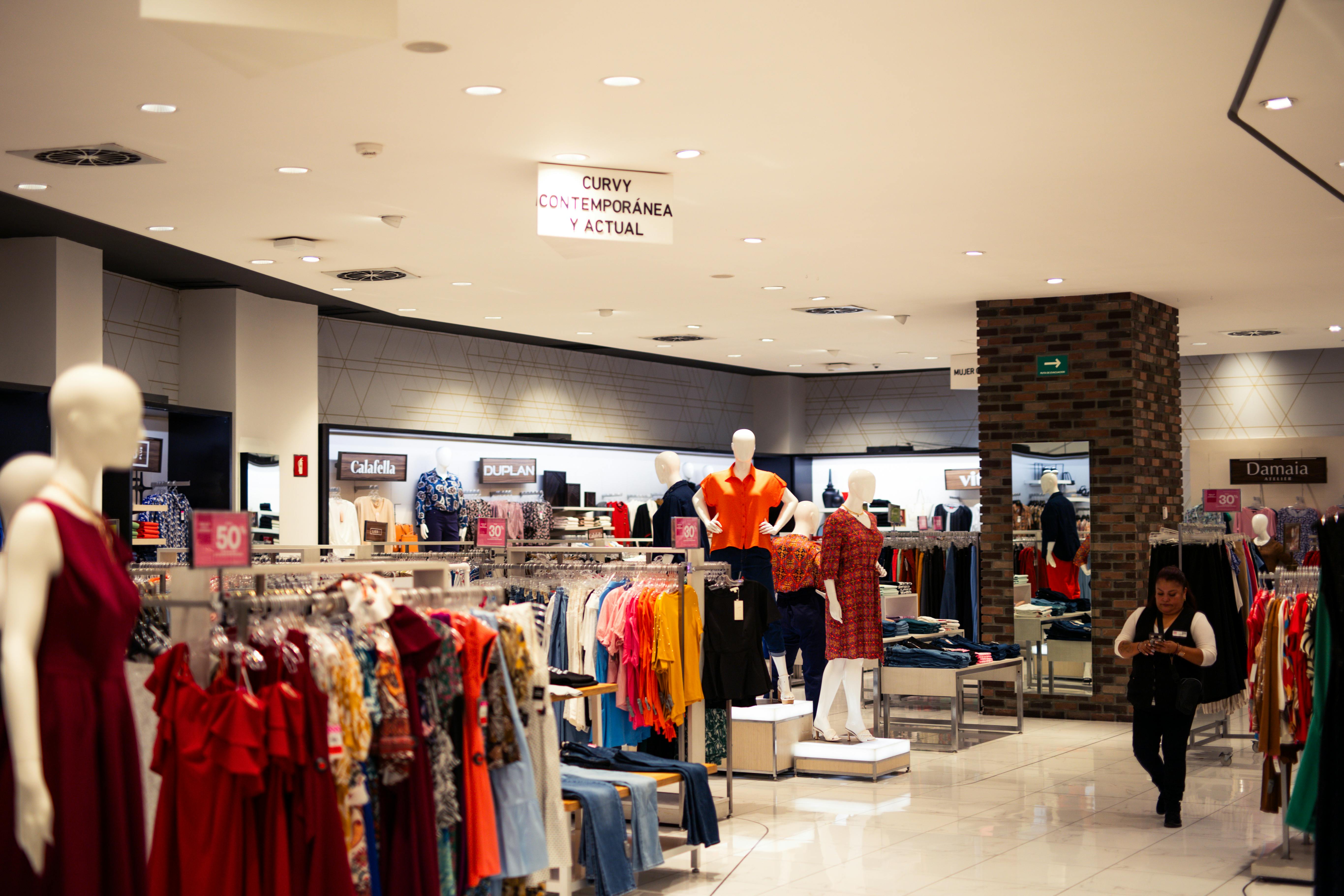 a store with many clothes on display and mannequins