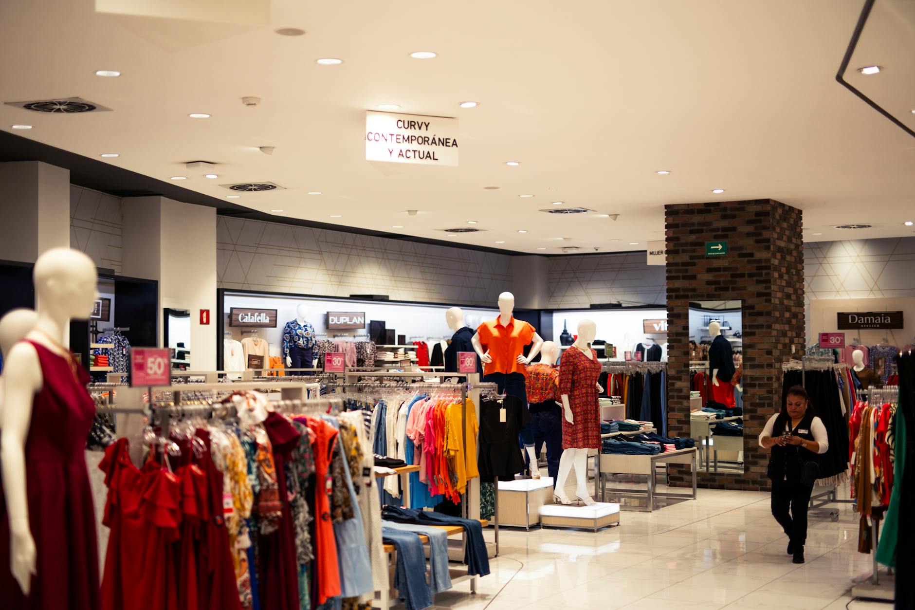 A store with many clothes on display and mannequins