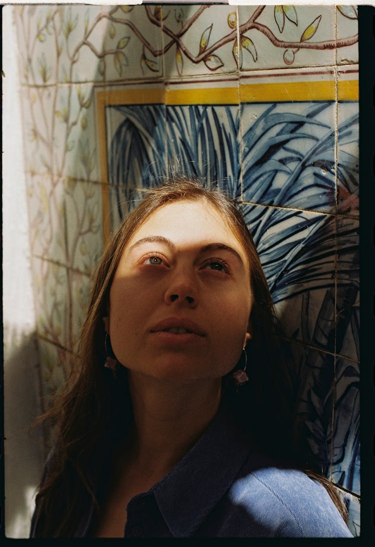 Portrait Of Woman With Painting On Wall