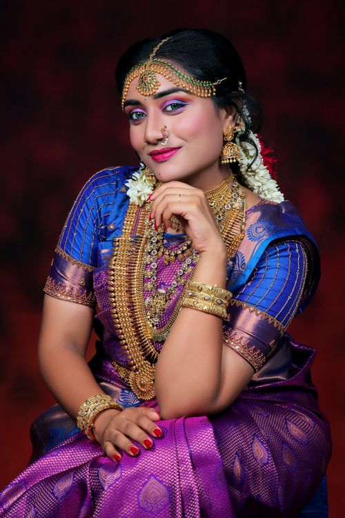 Free Beautiful Indian woman in vibrant traditional clothing and jewelry posing gracefully. Stock Photo