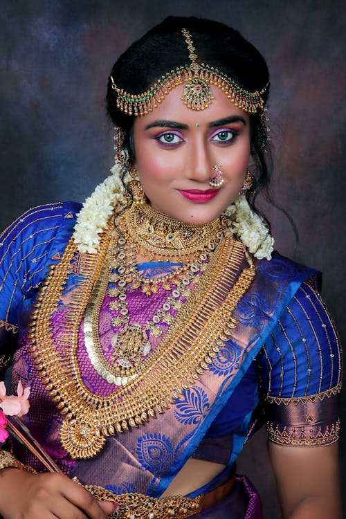Portrait of Woman with Golden Jewelry and in Traditional Clothing